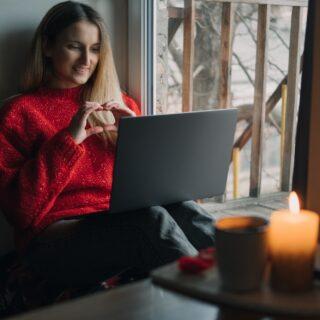 Woman using online dating app on laptop. Valentines Day During The Coronavirus Outbreak. Love at