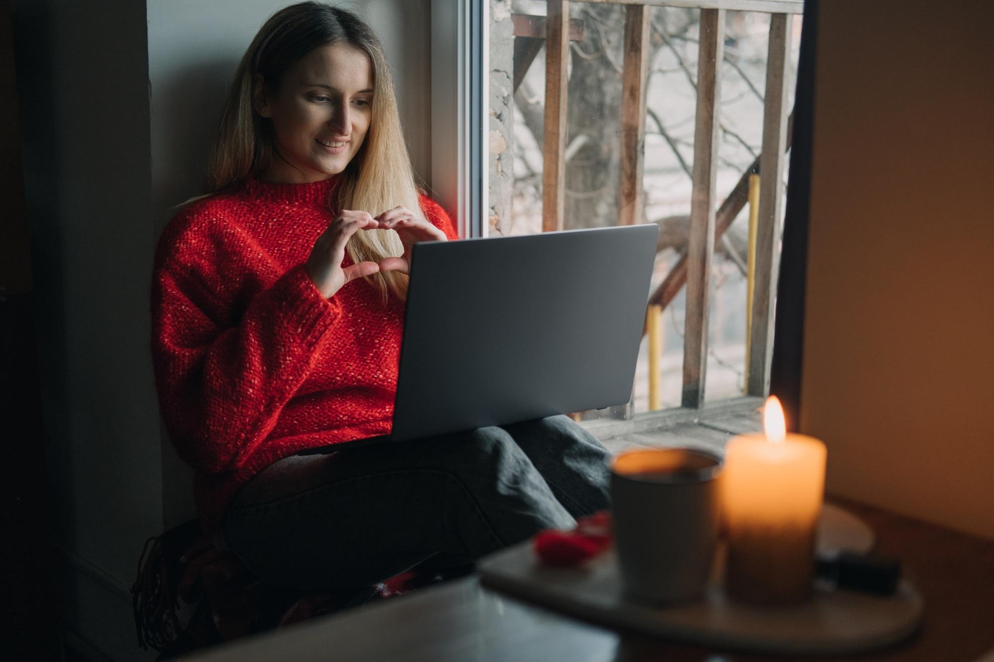Woman using online dating app on laptop. Valentines Day During The Coronavirus Outbreak. Love at